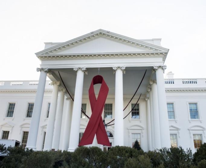 A red ribbon hangs over the North Portico of the White House in honor of World AIDS Day on Dec. 1, 2013.  (Brendan Smialowski/AFP/Getty Images)