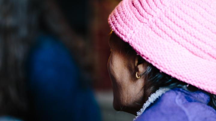 A female patient in a pink hat