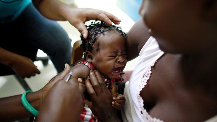 Child in Haiti getting a shot